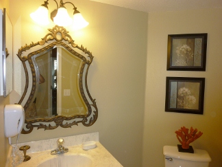 4th Bathroom has a single sink and a shower unit. Mirror and hair dryer. 